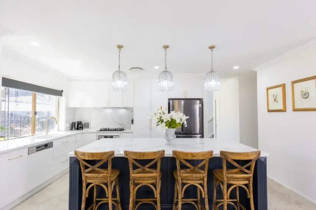 Pendant-lit kitchen island with navy base